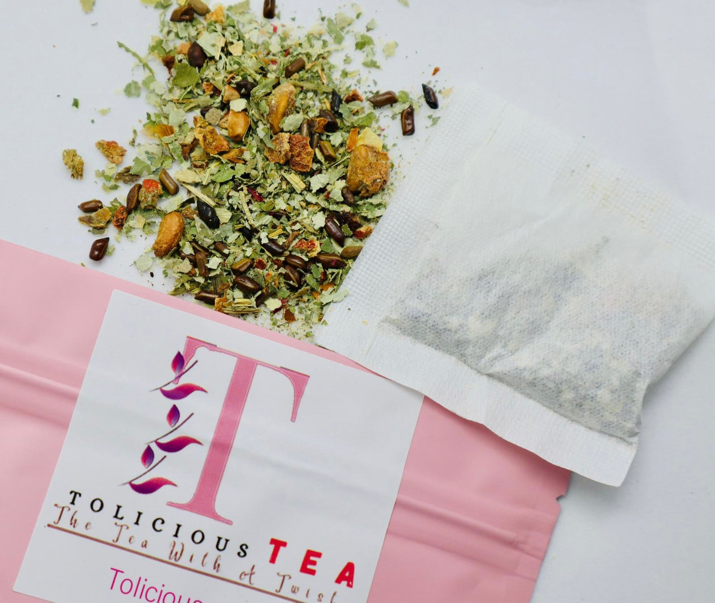 Tolicious wellness tea and detox gummies pack with loose herbal tea and a filled tea bag